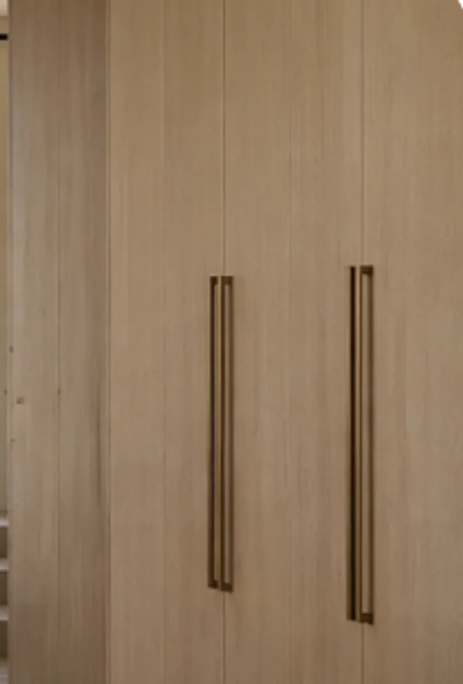 Material study of wood cabinet doors with warm metal handles